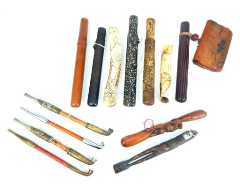 A collection of Japanese opium pipes, pipe holders and related items to include a pipe holder inlaid with abalone, 25 x 3 x 2