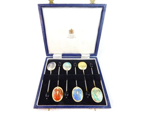 A cased set of 6x different coloured Mappin and Webb gilt and enamel coffee spoons with black glass coffee bean terminals  (6