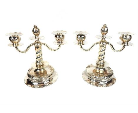 A pair of silver twin branch candelabra with pomegranate on hollow feet with repousse fruit decoration, possibly Swedish. 23.