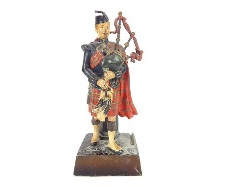 Scottish pipe major figure with bagpipes match striker, c1930, 19.5cm h