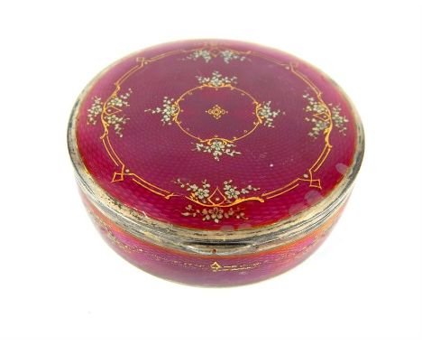 An antique French circular deep-pink guilloche enamel lidded box, hand decorated with small silver flowers and gilded detail 