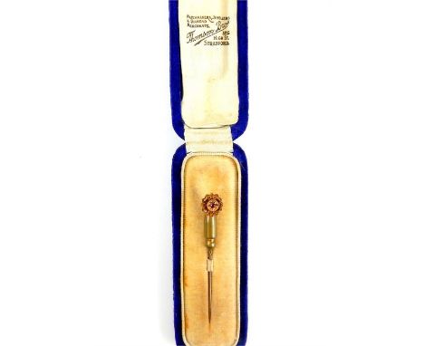 A yellow metal and ruby tie or cravat stick pin in original blue velvet box, the floral finial set with a small ruby within a