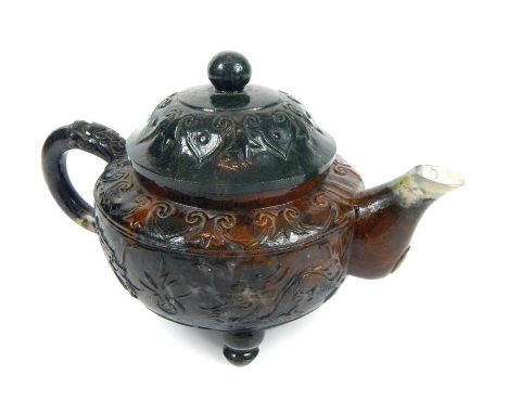 An unusual Chinese carved spinach jade teapot and lid, (the spout carved with seal mark).