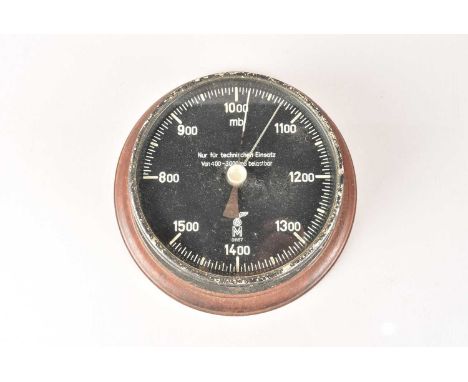 A German U-Boat Barometer, marked with an eagle and swastika, 'M' and serial 01167, dial 12cm diameter, on wooden mount
