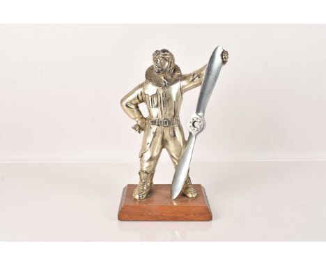 An RAF Pilot Table Lighter, chromed, in the form of a pilot holding a propeller, head hinged to the back, 27cm H