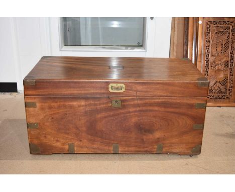 A Campaign Trunk/Chest, having applied brass mount to the corners, and cartouche to the centre of the hinged lid, compete wit