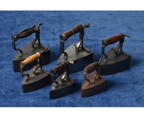 A small group of irons, comprising Wilkinson, Prilet Travel and Salter, two without slugs, each with a different turned woode