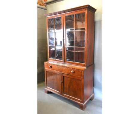 A 19th Century Mahogany Bookcase, the moulded cornice above two astragal glazed doors enclosing shelves, the lower section wi