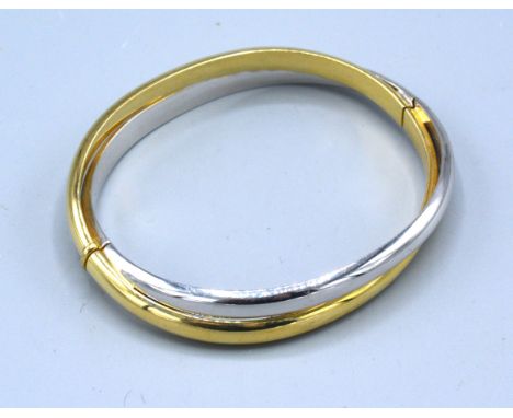 An 18ct. White And Yellow Gold Crossover Bangle 20.1 gms. 5 x 6 cms 