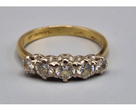 An 18ct gold five stone diamond ring, set with five graduated diamonds within a pierced setting, ring size K, 2.6 grams 