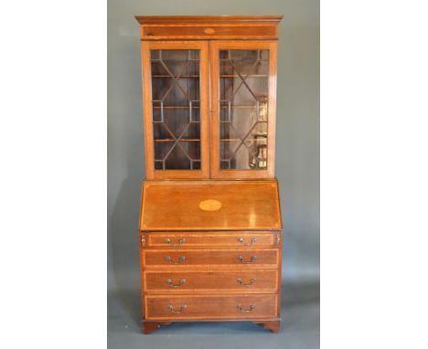 An Edwardian Mahogany Satinwood Inlaid Bureau Bookcase, the moulded cornice above two astragal glazed doors above a shell inl