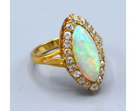 A Yellow Metal Dress Ring set with an opal surrounded by diamonds marquise set 5.2 gms. ring size L 