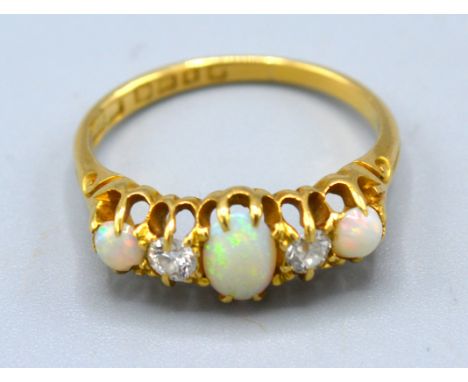 An 18ct. Gold Opal And Diamond Ring set with three opals and two diamonds within a pierced setting 3.8 gms. ring size O 