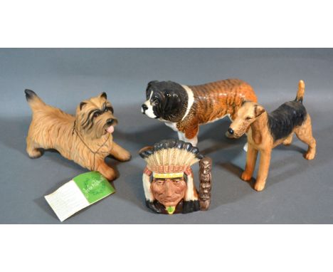 A Beswick Model Of A St. Bernard together with two other Beswick model dogs and a North American Indian D6614 character jug 