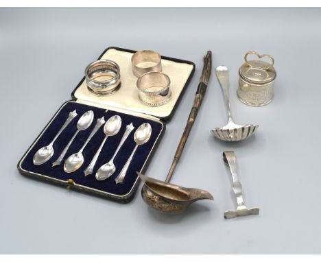 A Set Of Six Sheffield Silver Teaspoons Within Case together with a Sheffield silver cylindrical casket, three silver napkin 