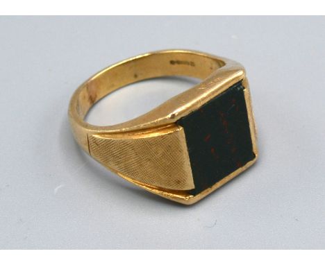 A 9ct. Yellow Gold Gentleman's Signet Ring set rectangular blood stone and with engine turned decorated shoulders, size Z, 9.