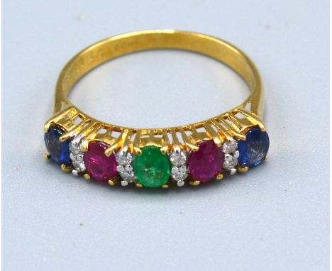 An 18ct Gold Multi Gem Set Band Ring set with sapphire, ruby, emerald and diamonds 2.4 gms. ring size L 