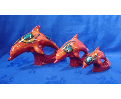 THREE POOLE POTTERY DOLPHINS IN DELPHIS COLOURS graduated