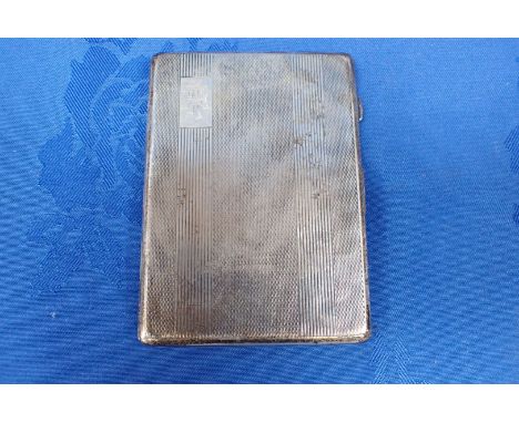 AN ENGINE TURNED SILVER CIGARETTE CASE with monogram and interior engraved inscription (dents)