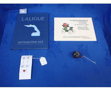 A LALIQUE 'AUTOMOTIVE ART' BOOK two silver lapel pins, three other car related lapel pins, and a Victorian bell