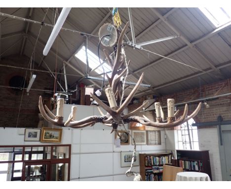 A KITSCH BARONIAL STYLE 'ANTLER' SIX-BRANCH CHANDELIER (cast resin) 80cm wide, 60cm drop (including ceiling rose and chain)