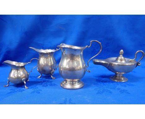 A SILVER ALADDIN TYPE LAMP, A SILVER MILK JUG and two three-footed cream jugs (4)
