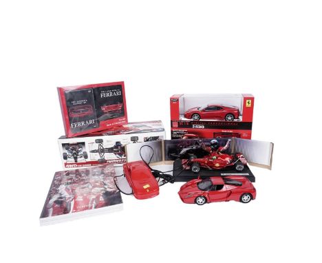 A Tamiya Ferrari F2001 1/10th scale radio controlled car, in its box; together with a collection of Ferrari related models an