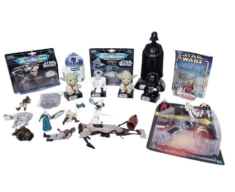 A selection of Star Wars collectibles, including: a carded Hasbro figure; loose figures; a Darth Vader alarm clock; and other