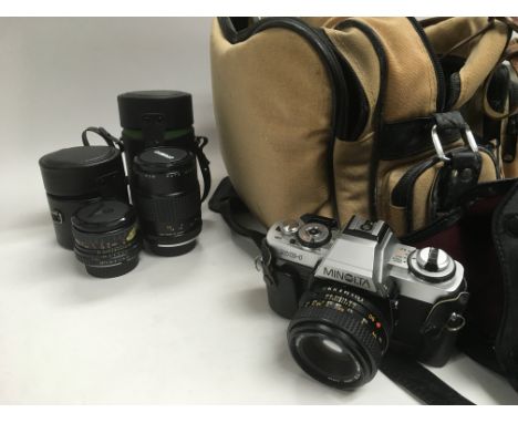 A camera bag, two Makinon lenses, a Minolta XG-1 camera and other photographic accessories.