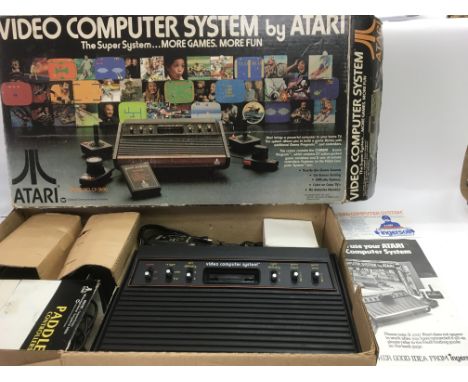 A boxed Atari CX2600 games console and accessories plus five boxed Atari games. See images for details.