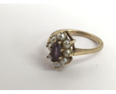 A 9ct gold ring set with central amethyst in pearl surround.Approx M