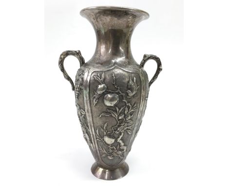 A Chinese, twin handled silver vase, decorated in relief fruit and vines.Approx 19cm