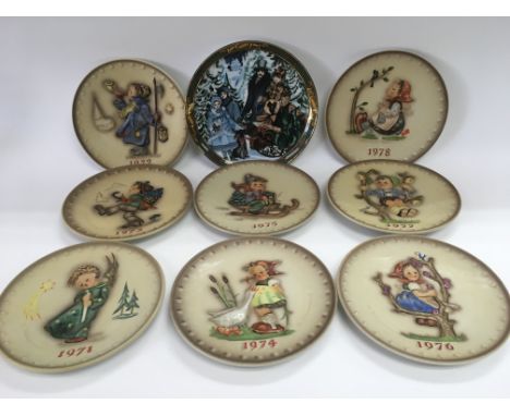 Two boxes containing various Goebel plates and bells, loose and boxed.