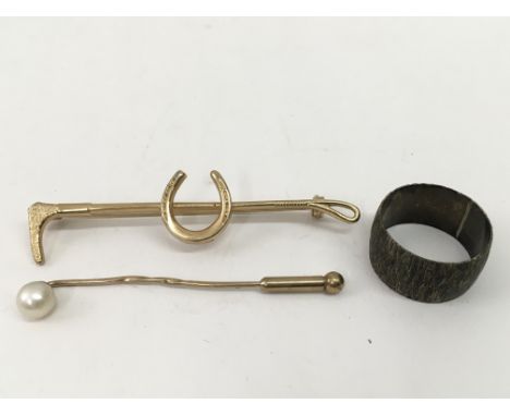 A gold and pearl stick pin, a silver rings and riding crop/horseshoe brooch