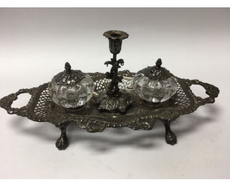 A Victorian silver silver desk stand inset with a pair of glass ink bottles and a single candle stick London 1846 ,30 cm by 1