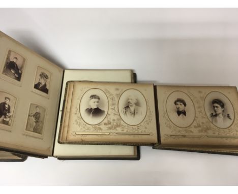 Two albums containing Victorian and later portrait photographs and a large Victorian bible (3)