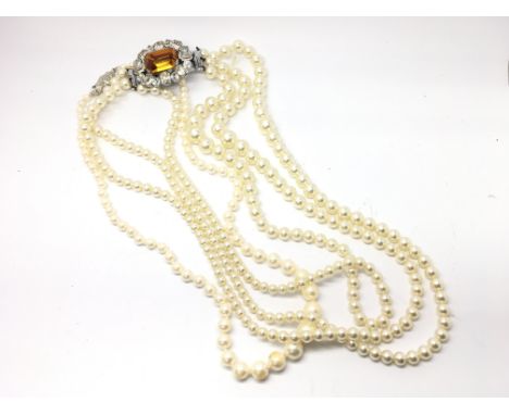 Two cased synthetic pearl neckalces with decorative clasps.