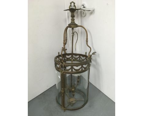 A large brass and glass lantern of rounded form, approx height 110cm.