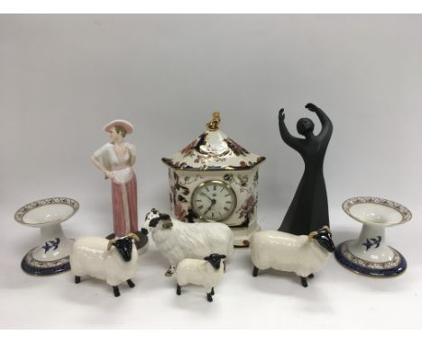 A collection of ceramics comprising four Beswick sheep, a pair of Royal Doulton blue and white chamber sticks, a Mason's mant