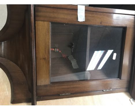 A small mahogany corner cabinet the single glazed door enclosing a shelf