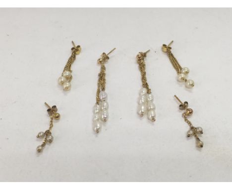 Three pairs of pearl earrings with gold mounts.