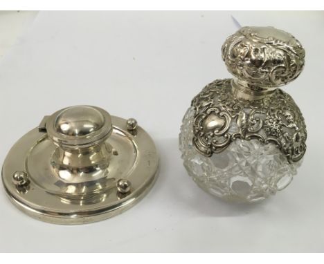 A silver mounted cutglass scent bottle decorated with cherubs, Chester hallmarks,1898, approx 12cm and a silver inkwell, Birm