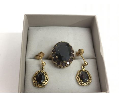 A gold garnet set ring and conforming drop earrings.Approx R