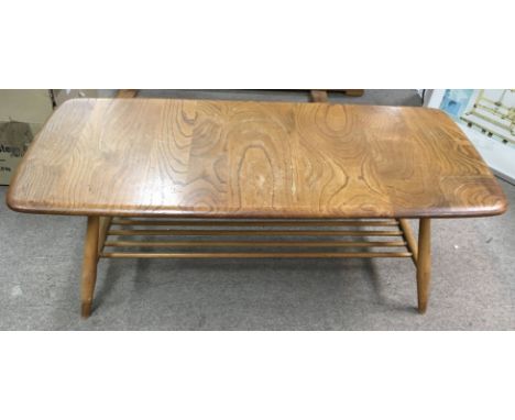 An Ercol light elm coffee table with undershelf.Approx 44x103cm