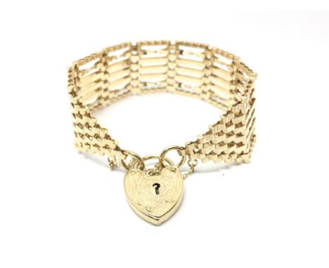 A 9ct gold seven bar gate bracelet with heart shaped padlock clasp, weight approx 26.8 grams.
