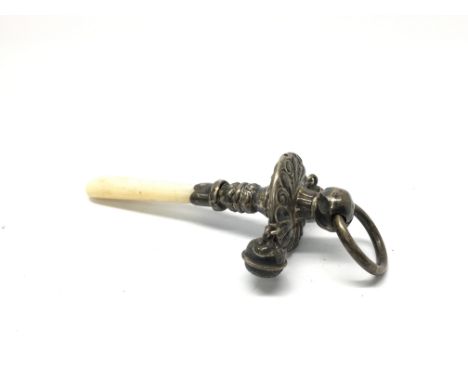 A silver rattle with mother of pearl handle.