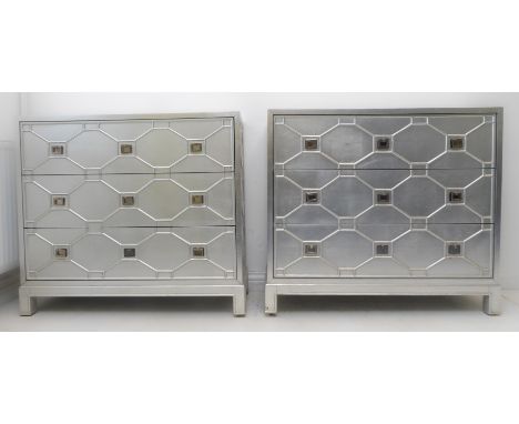 A pair of modern designer silver-coloured three-drawer chests with geometric fronts and on short square legs (99cm wide x 37c