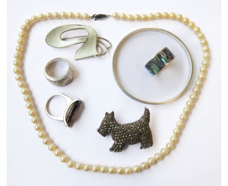 A selection of jewellery to include:  a Norwegian silver bangle set with a green enamel band; a cultured pearl necklace with 