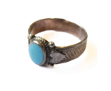 A silver textured ring: centrally mounted with a oval turquoise stone polished en cabochon (boxed)&nbsp;