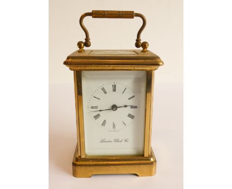 A modern gilt-metal and glass-sided carriage clock by the London Clock Company (plaque on top removed)&nbsp;